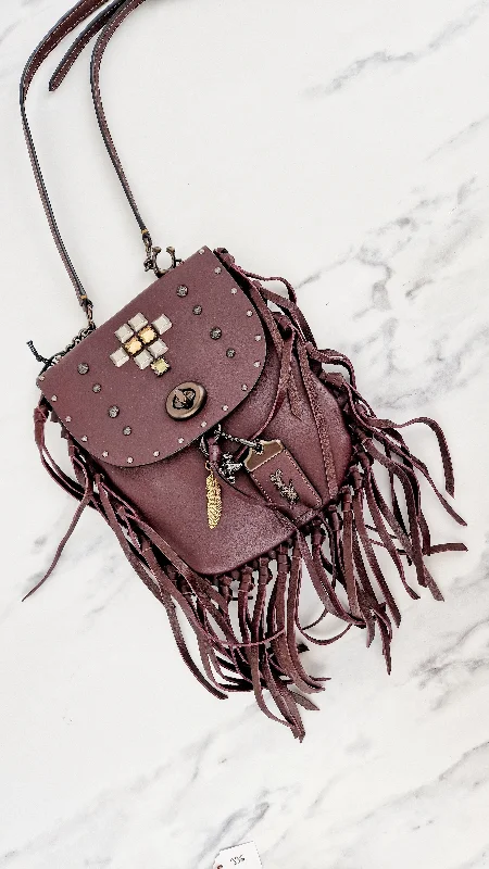 Coach crossbody bags with a keychain holder for practicalityCoach 1941 Fringe Saddle Bag Pyramid Rivets in Oxblood Smooth Leather & Ram Charm - Coach 48617